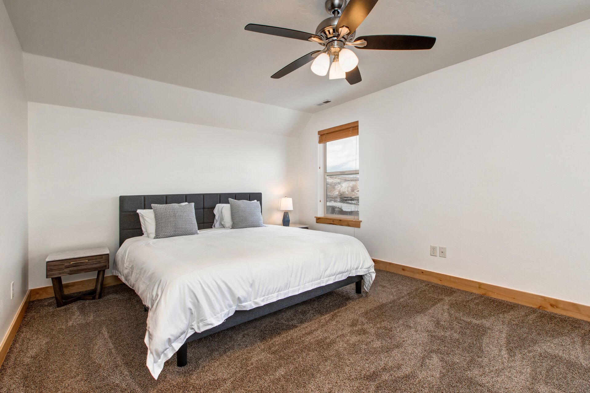 Upper Level Bedroom 2 with king bed, small work area, walk-in closet and en suite bathroom