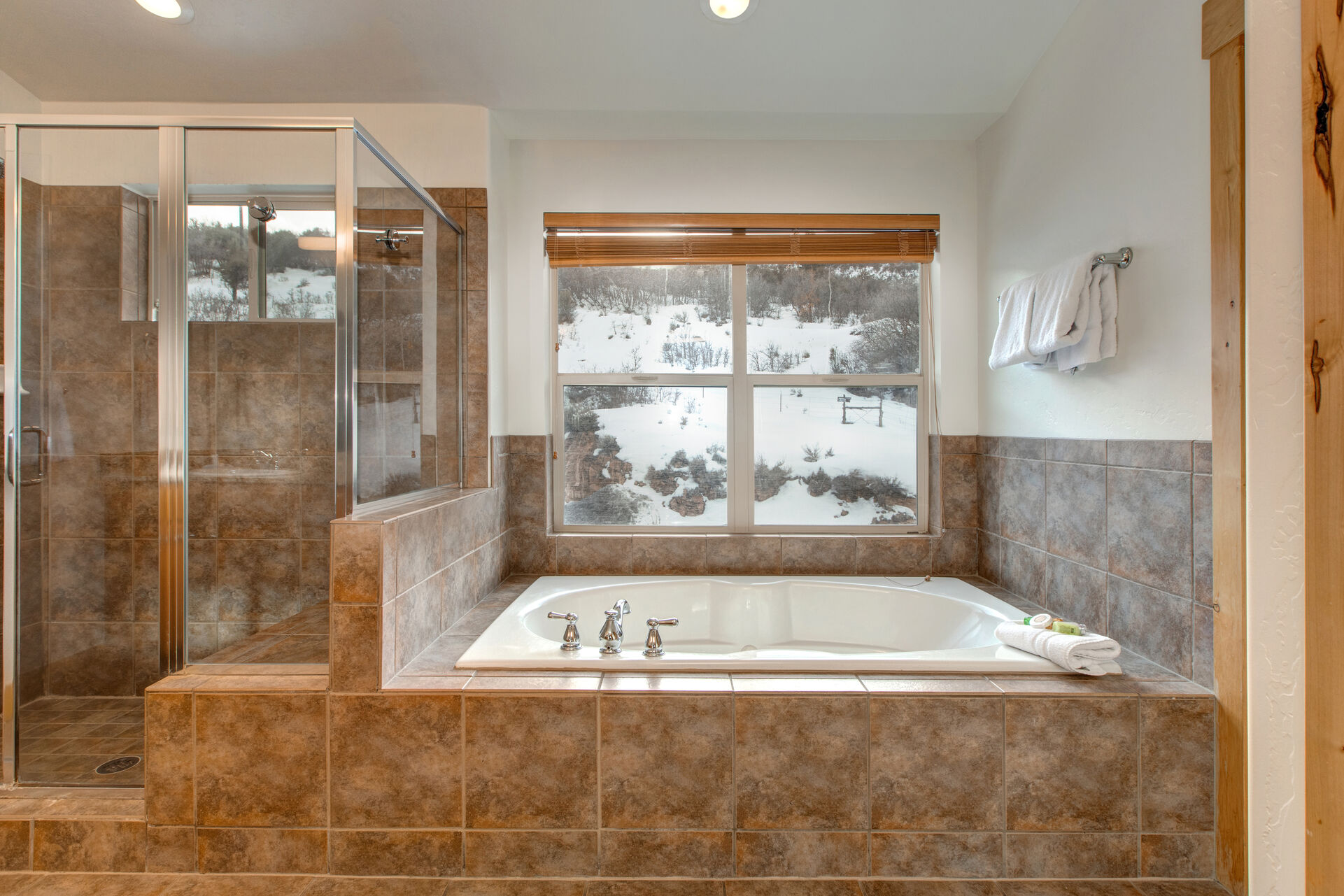 Master Bathroom with dual vanity, over-sized tile shower, separate wash room, and large jetted tub