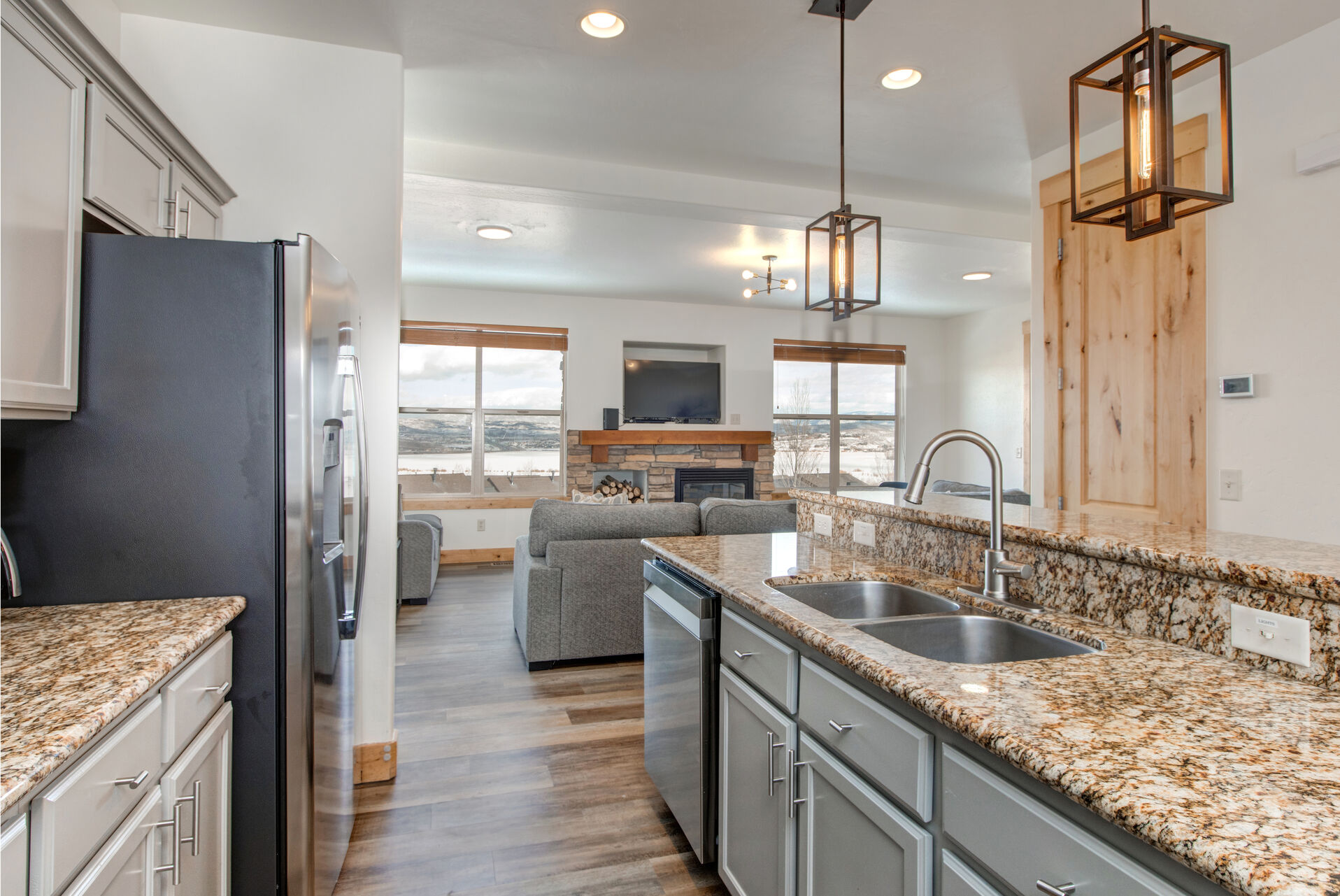 Fully Equipped, gourmet kitchen with beautiful stone countertops, separate island, ample prep space, stainless steel appliances, icee-maker, and bar seating for four