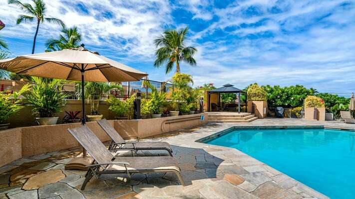 Kona Pacific swimming pool with seating and umbrellas