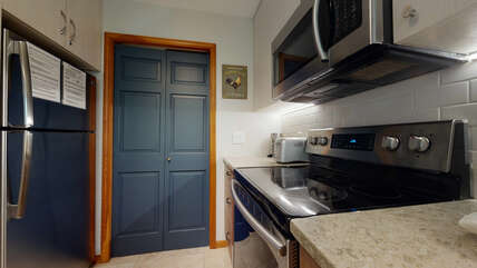 Fully Equipped Kitchen Leading to In-Suite Laundry