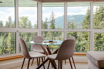 The dining area is situated in the living space with a beautiful view of Mountains and Trees