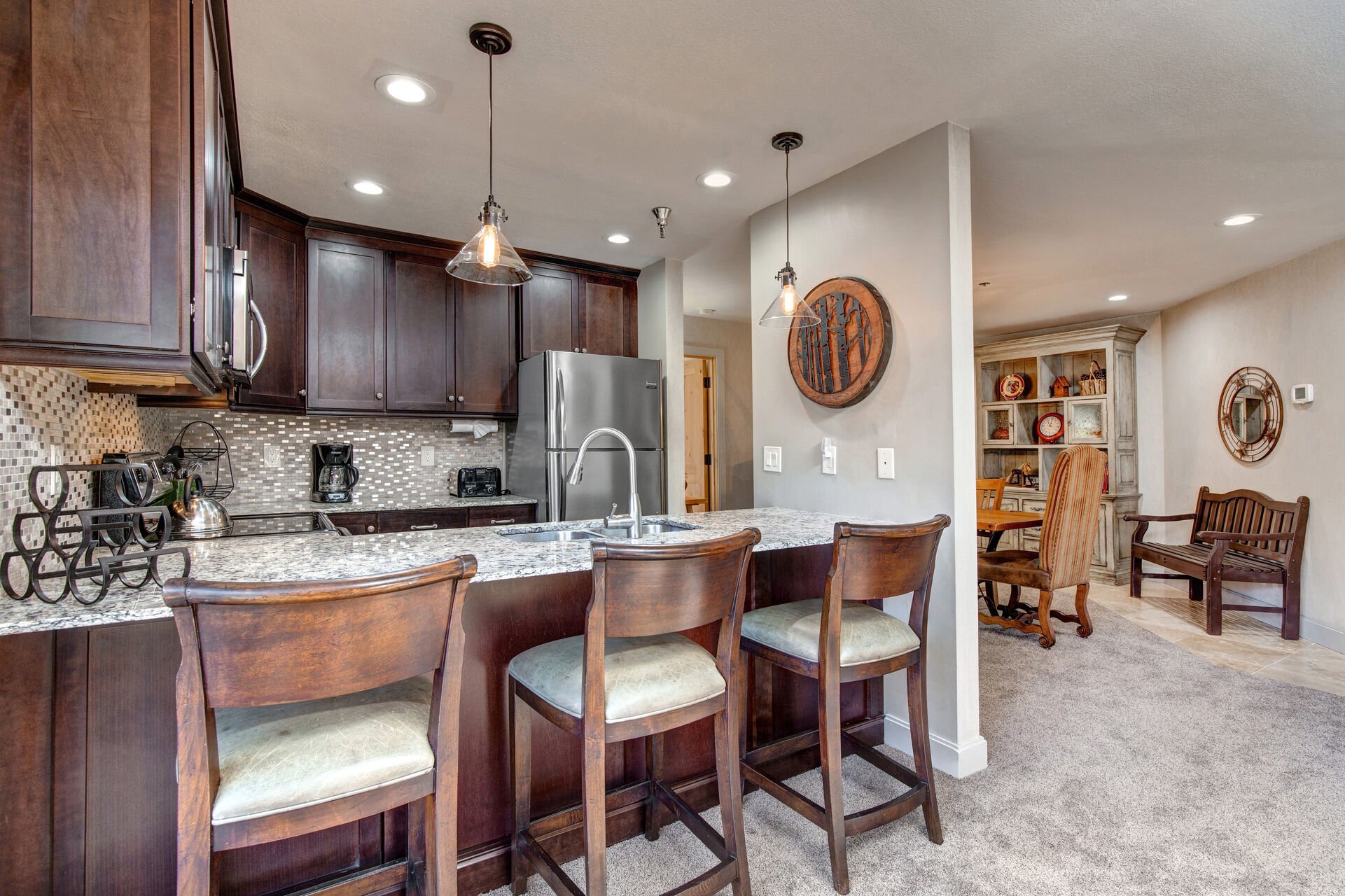 Kitchen with Stone Counters and Bar Seating for Three