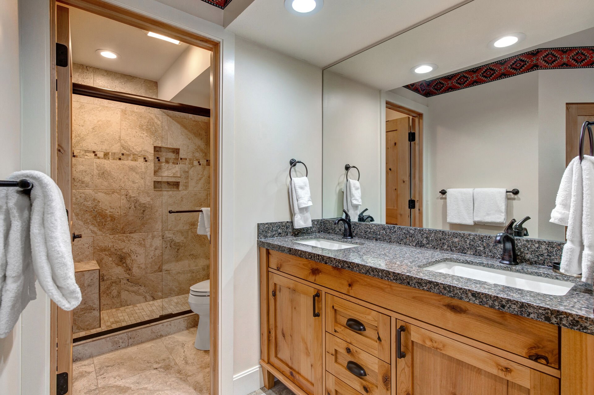 Master Bath with Dual Stone Counter Sinks and a Separate Tile/Glass Shower