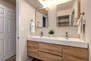 Shared Full bathroom with dual vanities, separate washroom and tub/shower combo