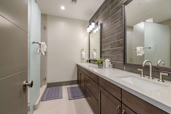 Full Shared Bath with Dual Stone Counter Sinks and a Shower