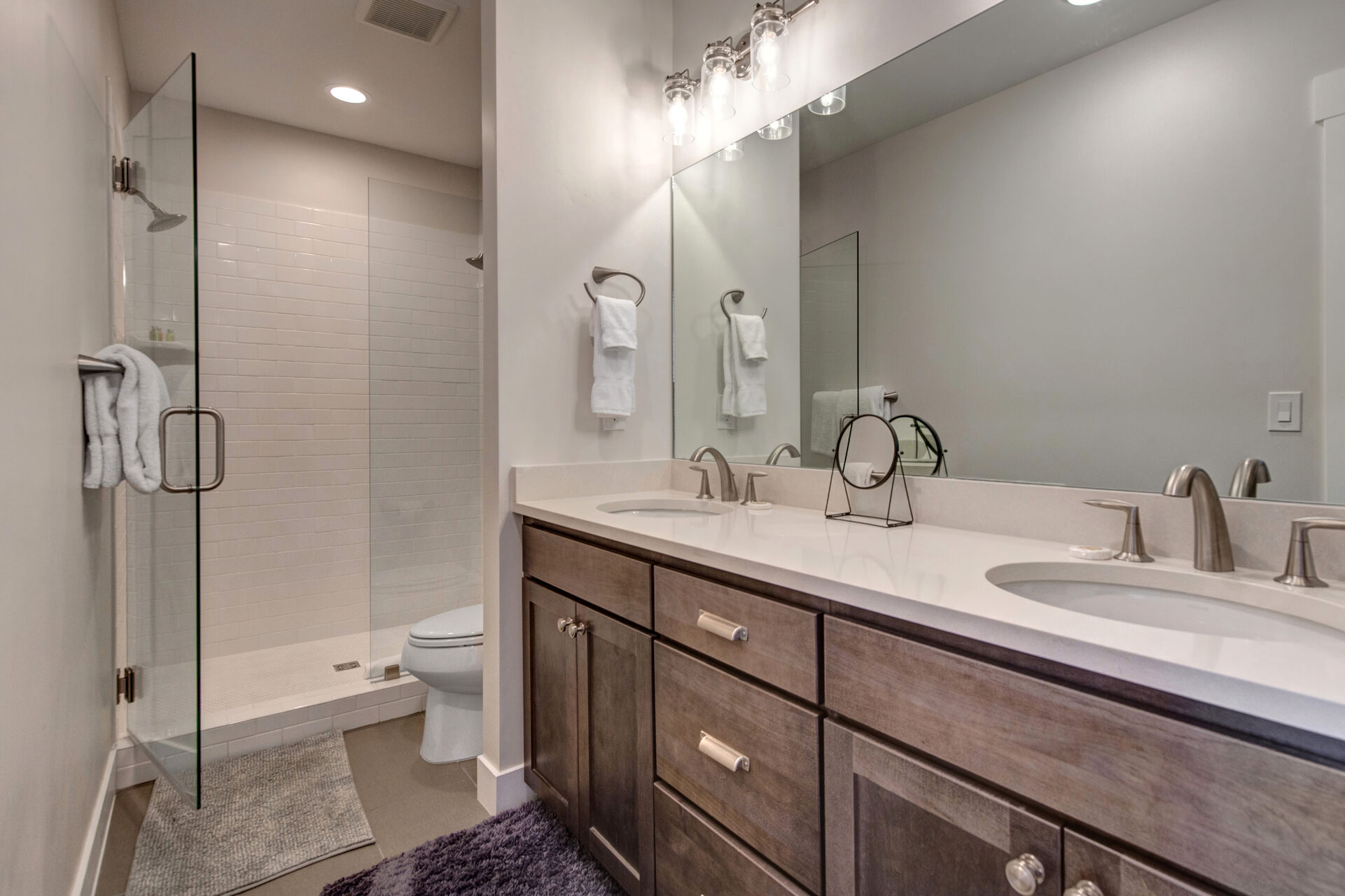 Master Bathroom with dual sinks and large tiled shower with two shower heads