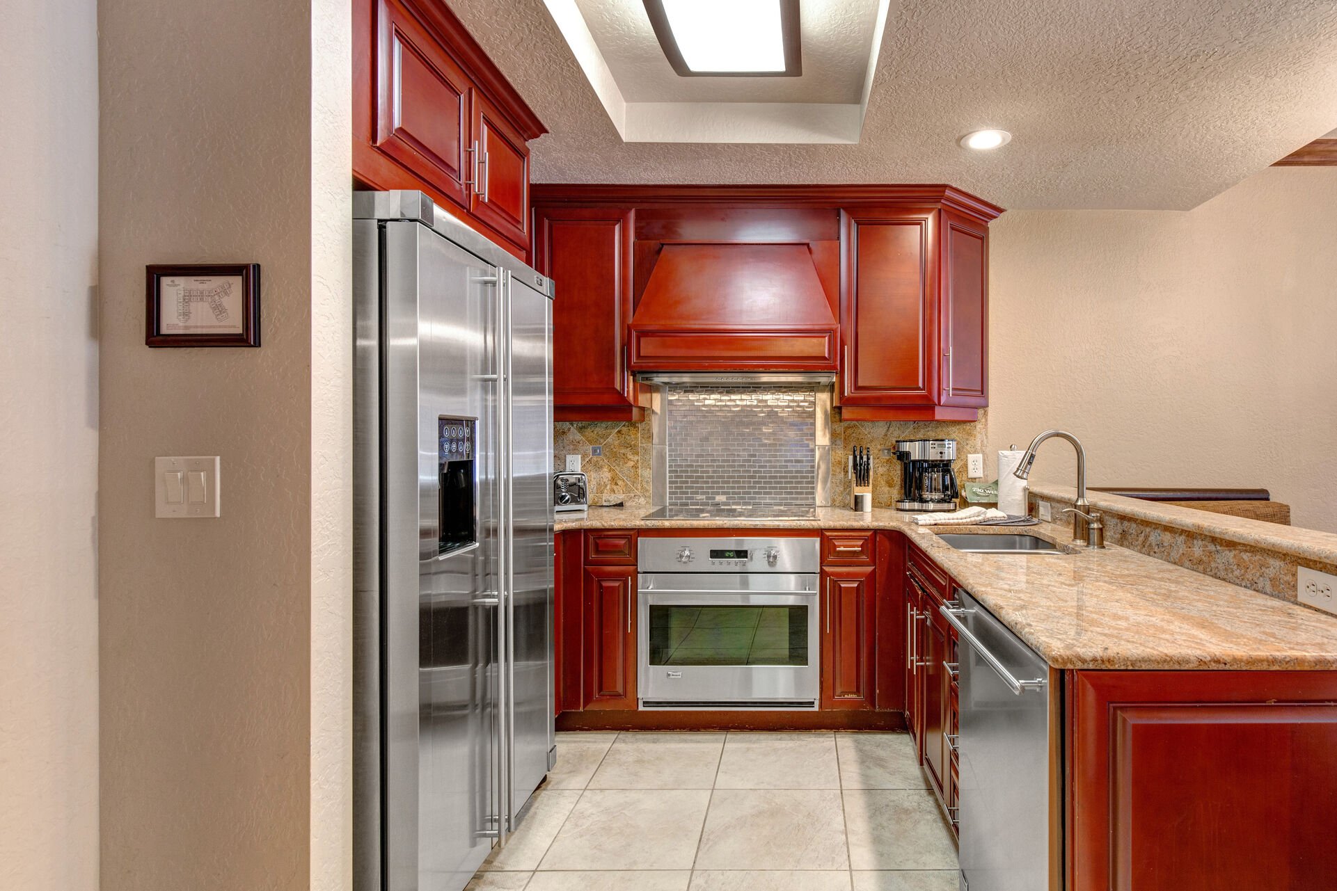 Fully Equipped Kitchen with stone countertops, stainless steel appliances, and ice maker