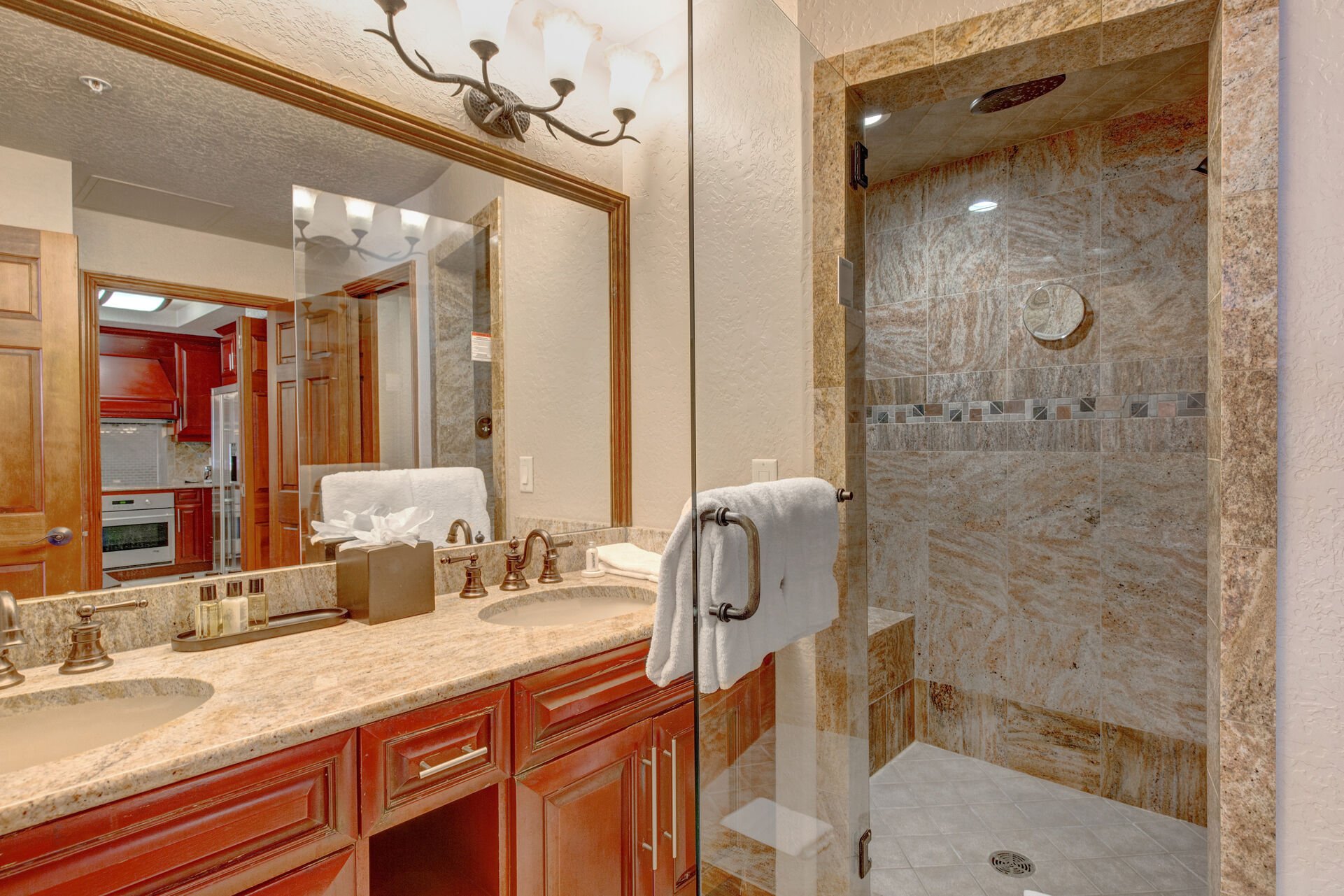 Jack-n-Jill Bathroom with dual sinks, large tiled shower, separate wash closet and Master Bedroom access