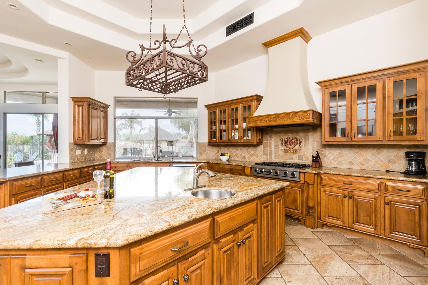 The kitchen is a chef's dream, with stainless-steel appliances, a large island with ample counter space, double oven, bar seating, and stocked with all culinary essentials.