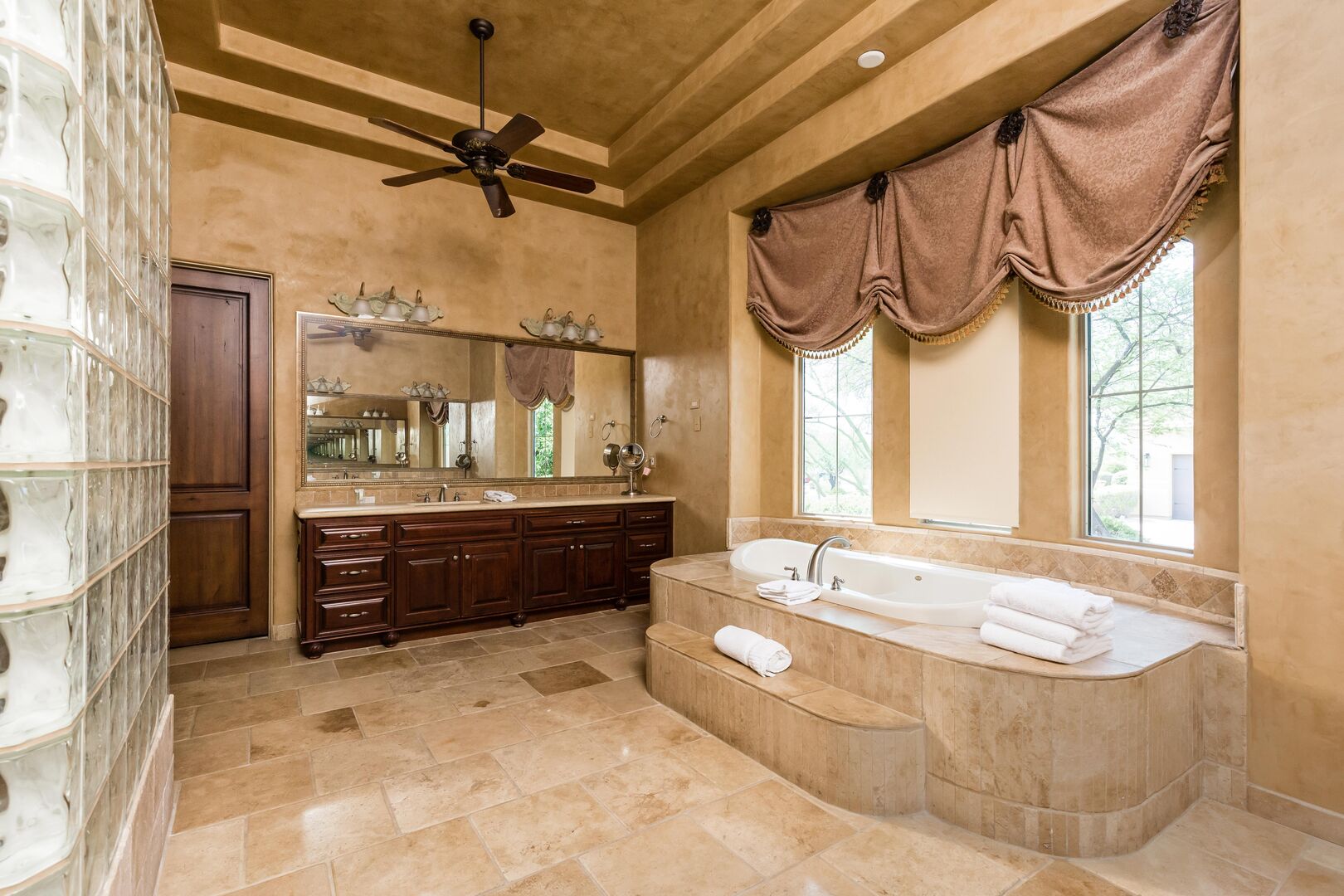 Luxurious Primary Bathroom featuring a soaking tub, a stand-in shower, and 2 oversized vanities.