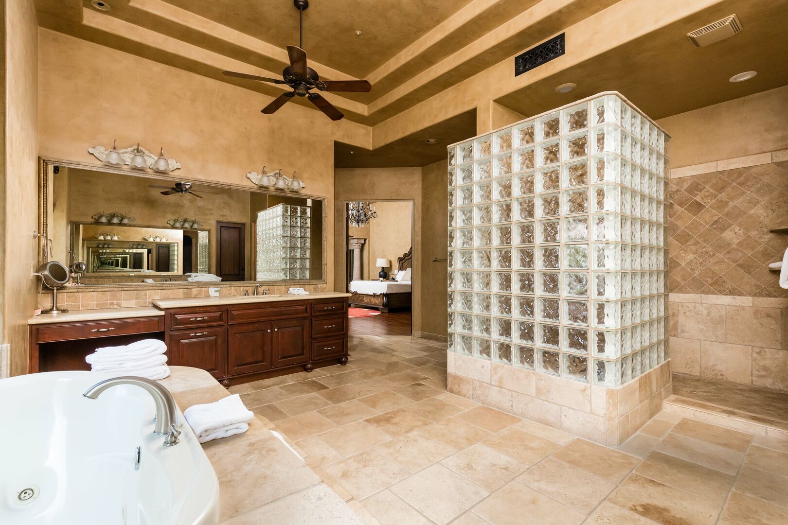 Luxurious Primary Bathroom featuring a soaking tub, a stand-in shower, and 2 oversized vanities.