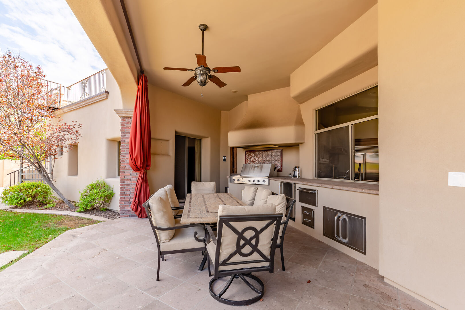 Covered backyard patio offering outdoor dining, and a built-in BBQ / outdoor kitchen area.