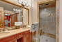 Jack-n-Jill Bathroom with dual sinks, large tiled shower, separate wash closet and Master Bedroom access