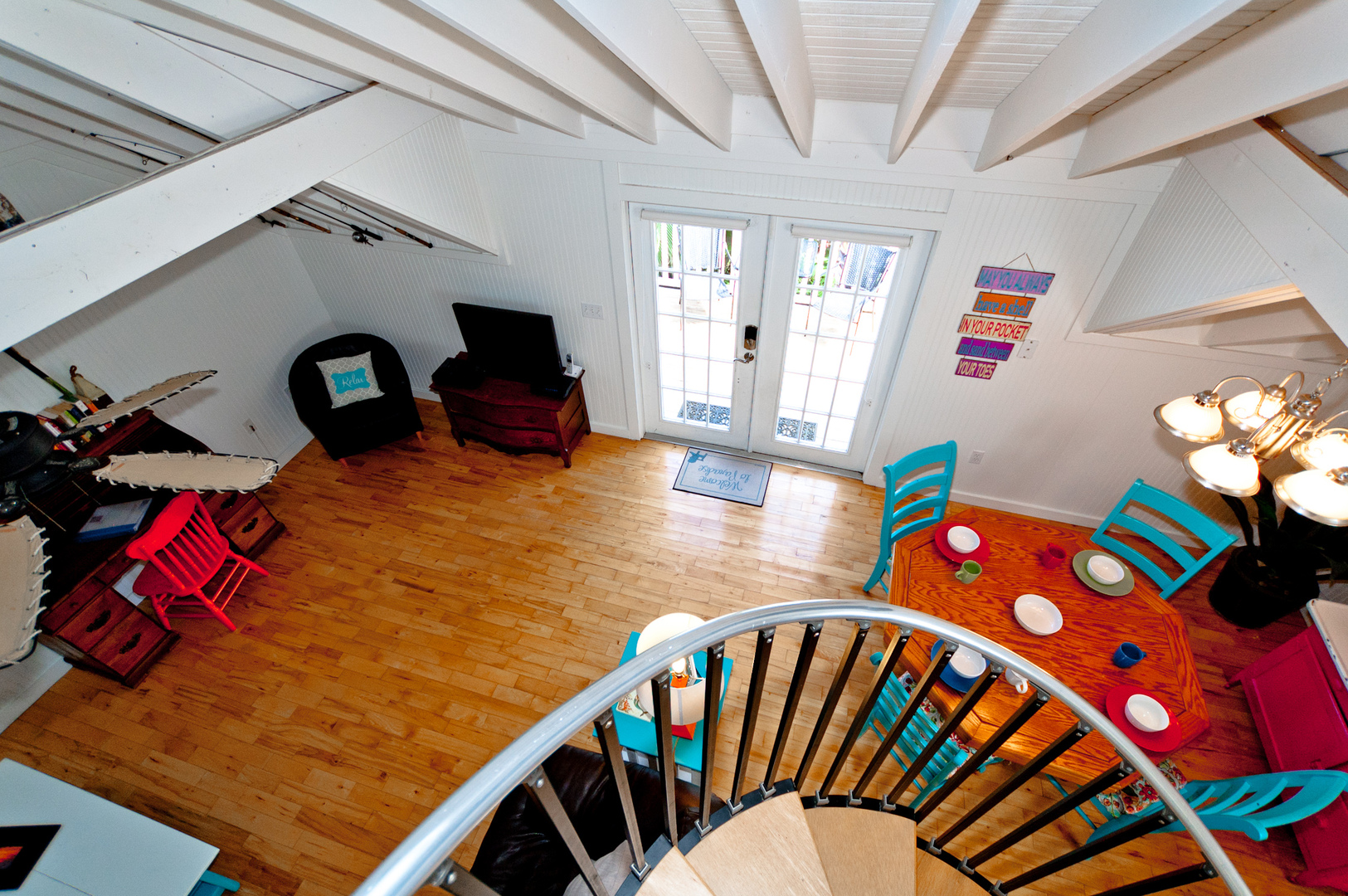 Crows Nest Spinnakers Cottages spiral staircase looking down to front entry door