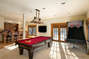 Lower level game room has it all, full size pool table, basketball game, bar, large television!