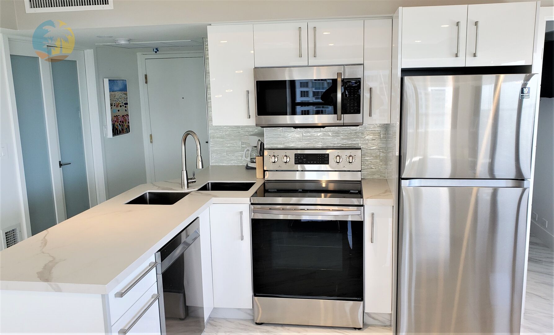 Fully Equipped Kitchen, double stainless sink, solid surface counter.