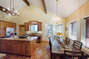 Bright space, dining room table with chair and bench seating.