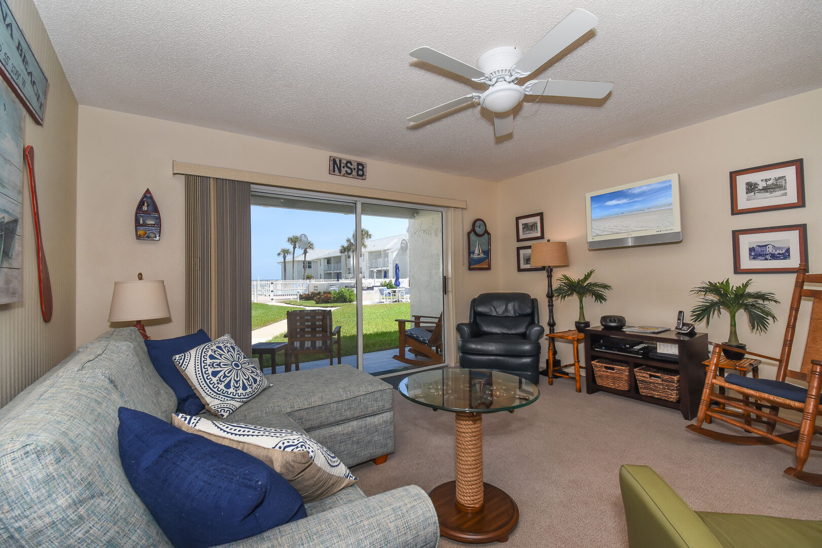 The ocean view living room features a cozy furnishings, sofa sleeper, a flat screen TV and DVD player. 