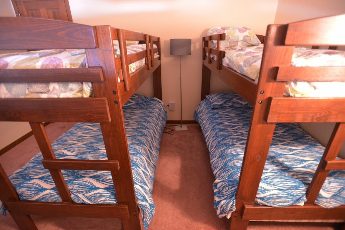 Half wall loft with private door has two bunk sets.