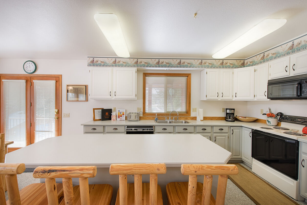 Well equipped kitchen has counter seating.