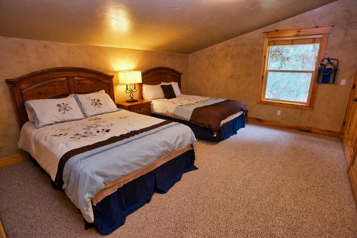 Guest room with queen beds upstairs.
