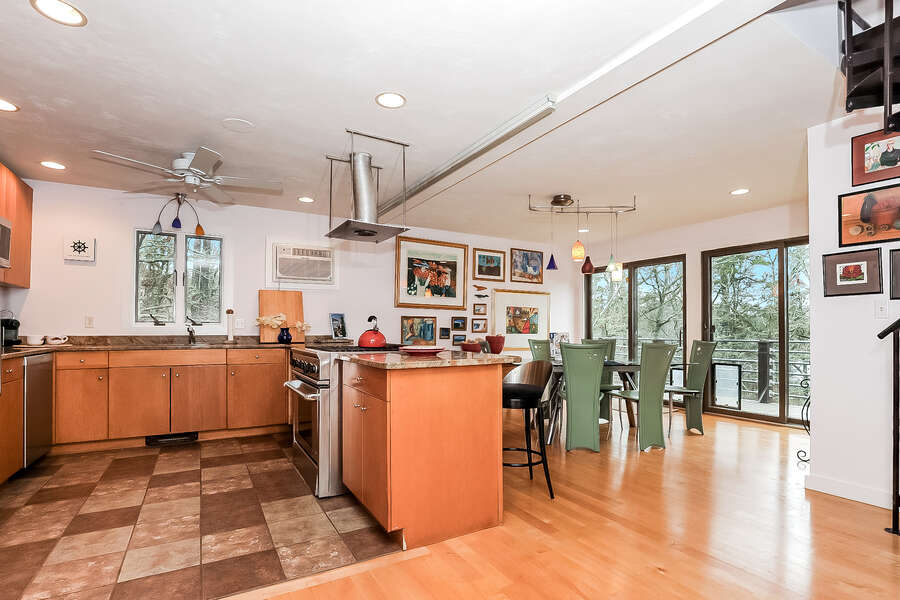 Open concept kitchen and dining area, large gas stove and oven all with a view of the pond-10 Cranberry Hollow Harwich-Cape Cod- New England Vacation Rentals-#BookNEVRDirectArtfulView
