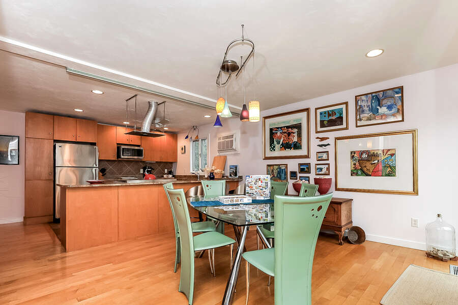Dining table with seating for 6 looks into the open concept kitchen-10 Cranberry Hollow Harwich-Cape Cod- New England Vacation Rentals-#BookNEVRDirectArtfulView