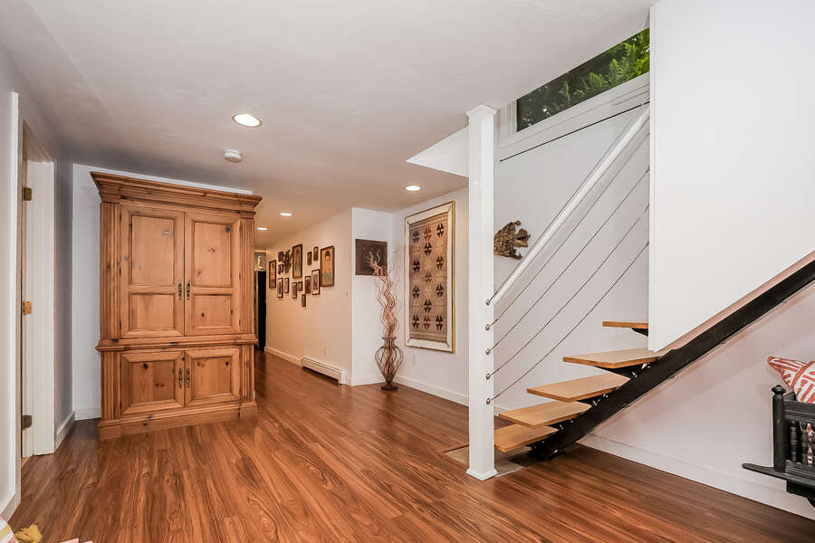 Finished basement hallway looking toward bedroom #4 at the end on the left-10 Cranberry Hollow Harwich-Cape Cod- New England Vacation Rentals-#BookNEVRDirectArtfulView