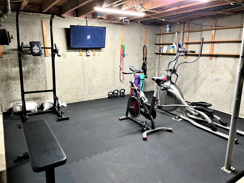 New for 2022!  Fitness area in basement with equipment, free weights and a smart TV - 2 Cove Road Harwich Cape Cod - New England Vacation Rentals- #BookNEVRDirectCozyCove