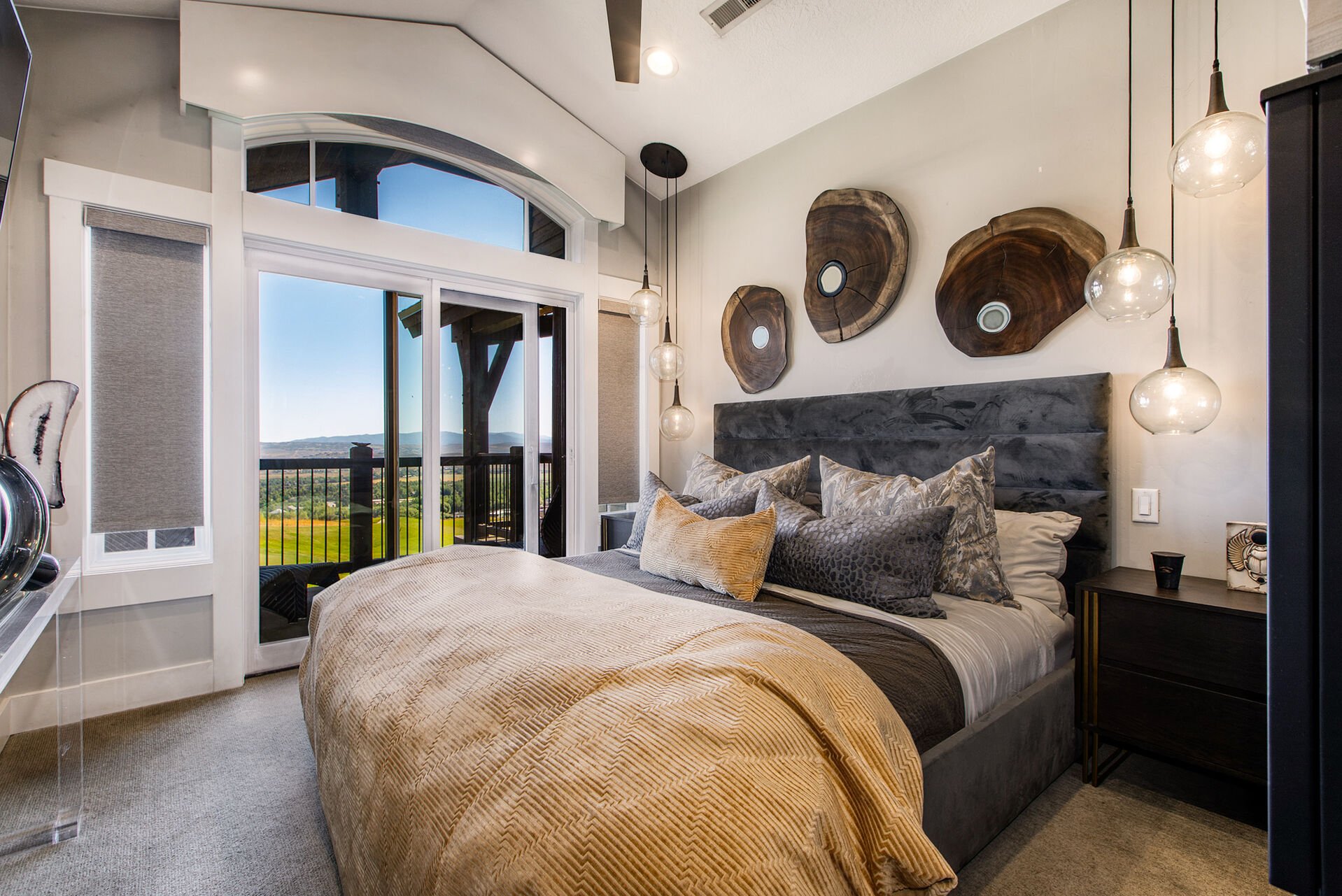 Master Bedroom with King Bed, Contemporary Decor, Double-sided Gas Fireplace, and a Deck with Stunning Views