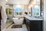 Master Bathroom with Dual Stone Counter Sinks, a Soaking Tub, and Separate Tile/Glass Shower
