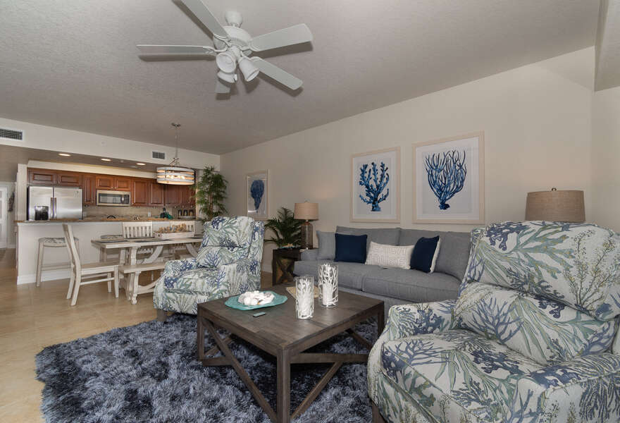 living room furniture and kitchen and dining area within condo rental in new smyrna beach