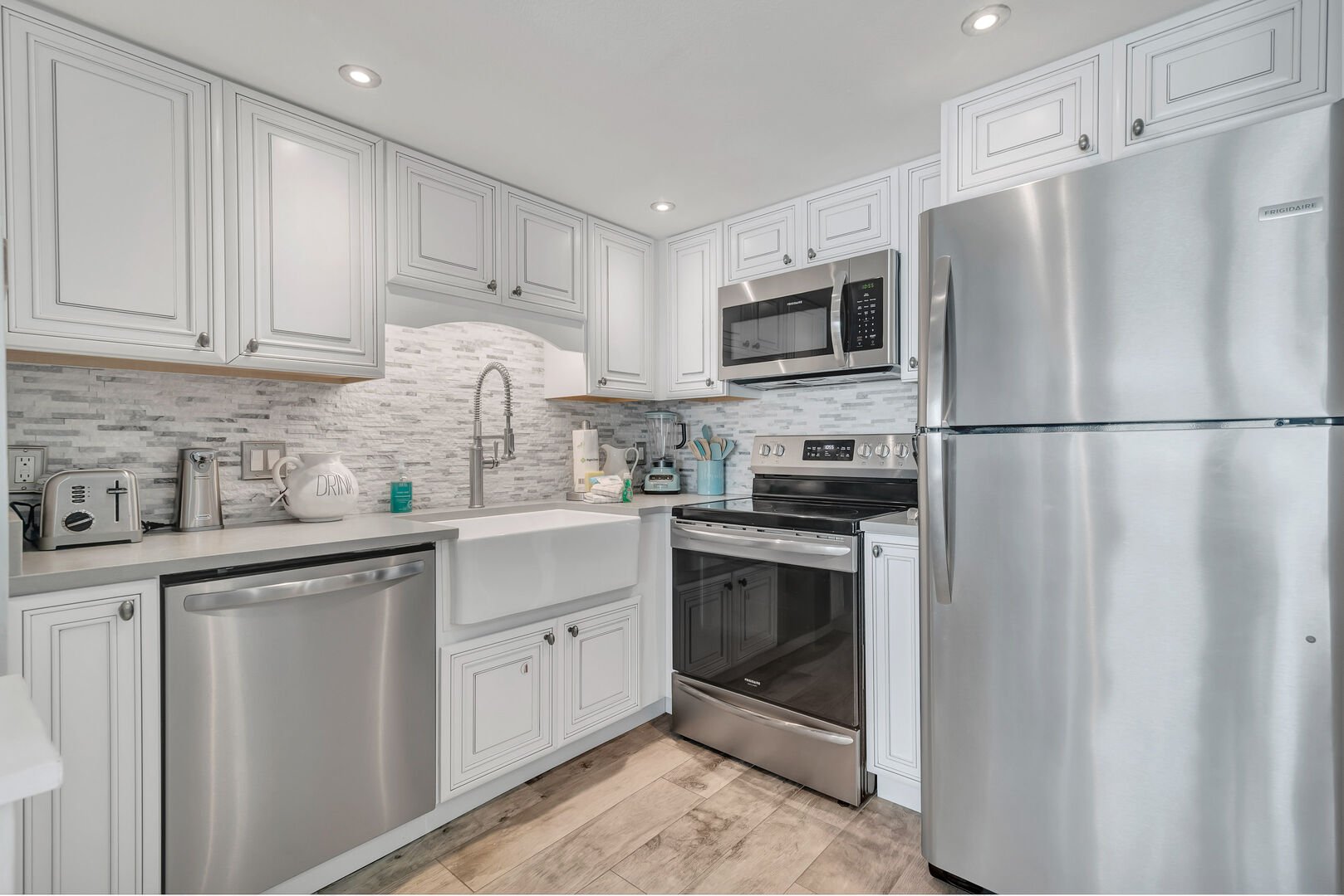 Fully Equipped Upgraded Kitchen with Quartz Countertops and Stainless Steel Appliances