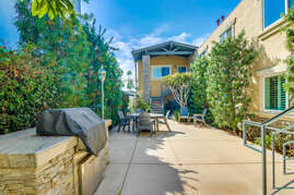 Communal courtyard with shared grill and patio set.
