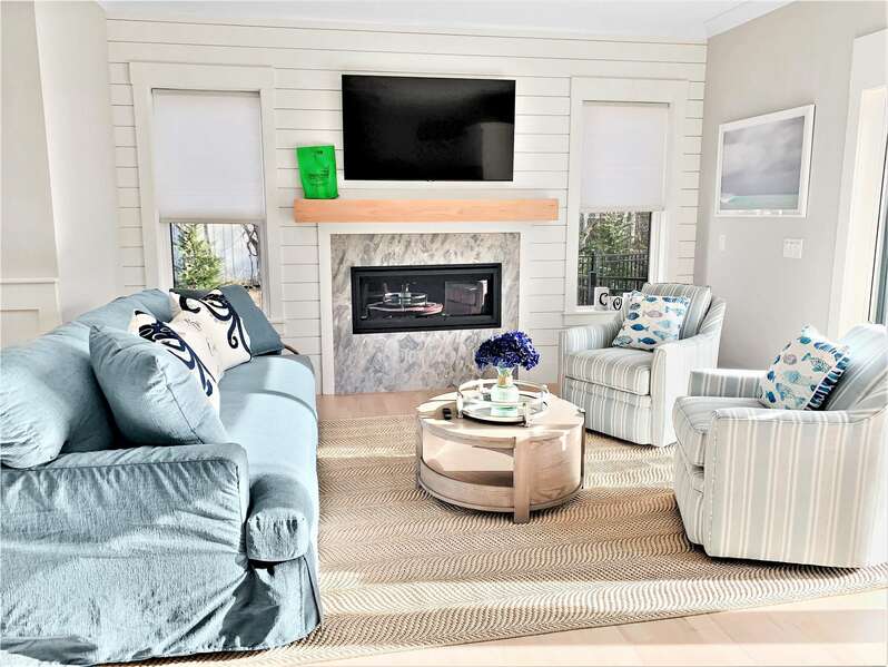 Comfy couch and swivel chairs with pool view through sliders-31 Pine Rd West Dennis- Cape Cod- New England Vacation Rentals