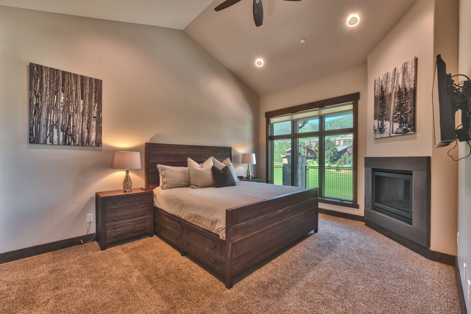 Master bedroom has a king bed and fireplace