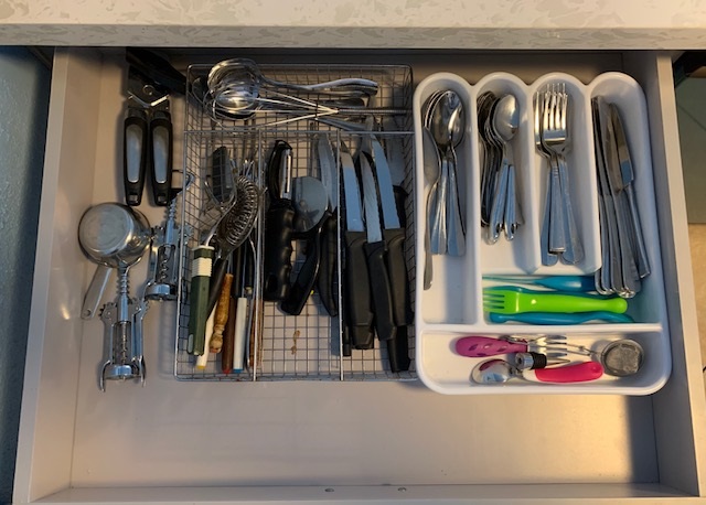 THE DRAWERS ARE STOCKED WITH EVERYTHING FROM WINE OPENERS TO WISK