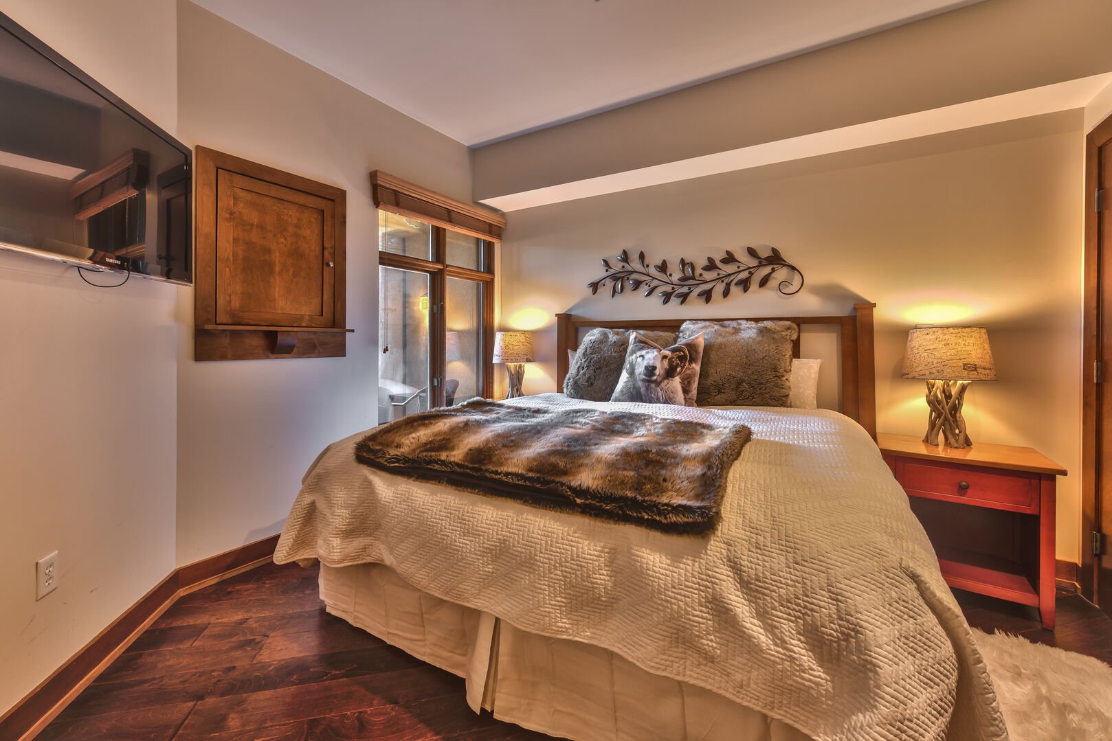 Bedroom features a king bed, European duvet, flat screen TV