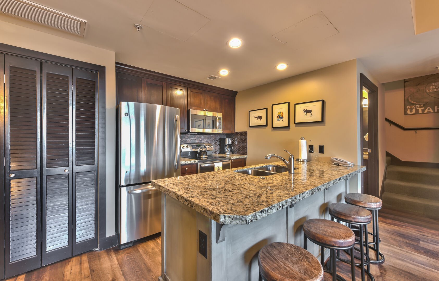 Kitchen features granite and stainless