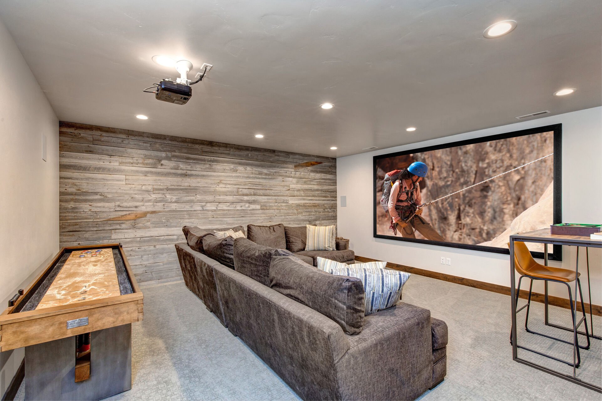 Lower Level Theater / Game Room with a Shuffleboard Table, Big Screen and Projector