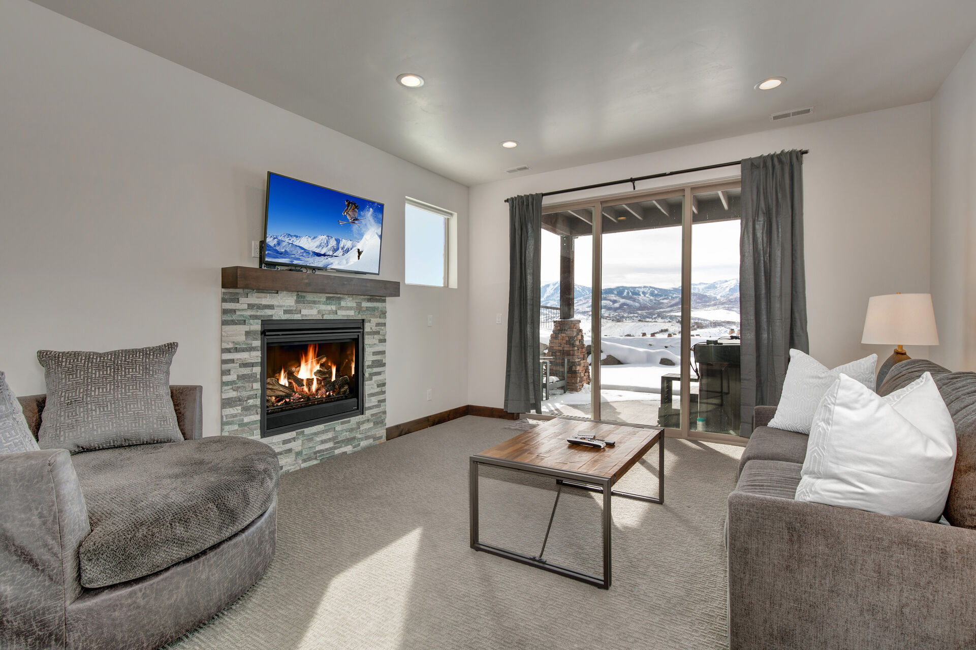Lower Level Family Room with a Gas Fireplace, Smart TV and Patio Access with a Private Hot Tub and Views