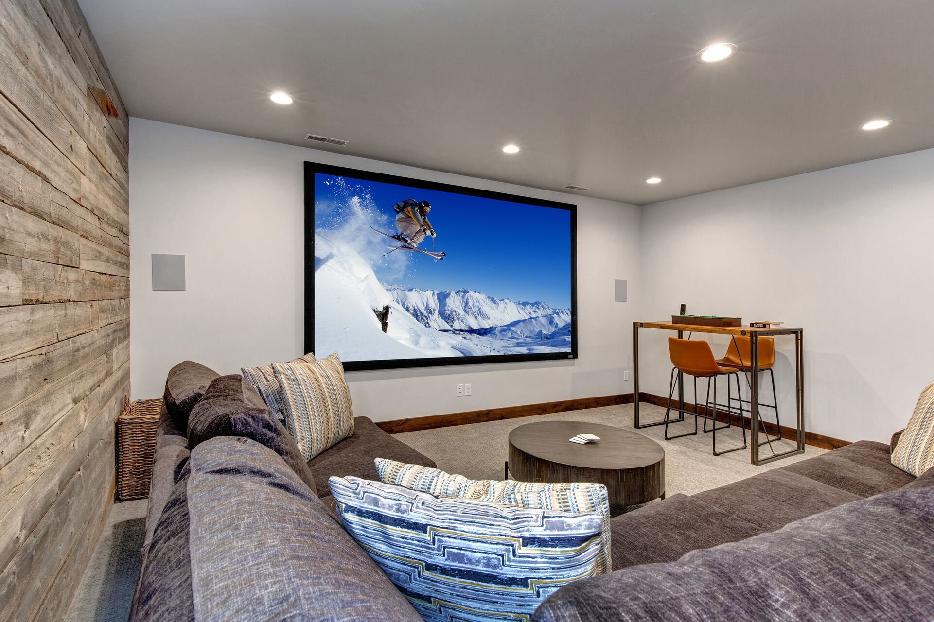 Lower Level Theater / Game Room with a Large Cozy Sectional and Game Table