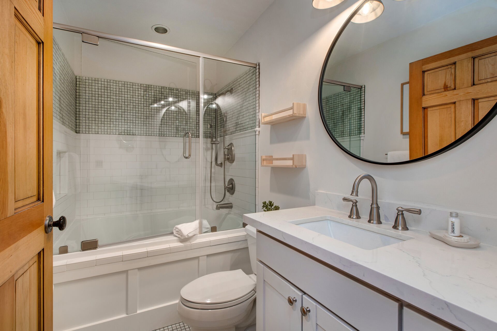 Main Level Full Bathroom with large tub/shower combo with detachable shower head, and beautiful stone countertops