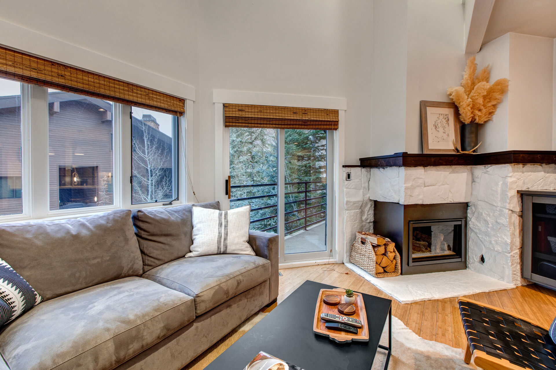 Living Room with samsung smart tv, private patio access, gas fireplace, and sectional with built in sofa-bed