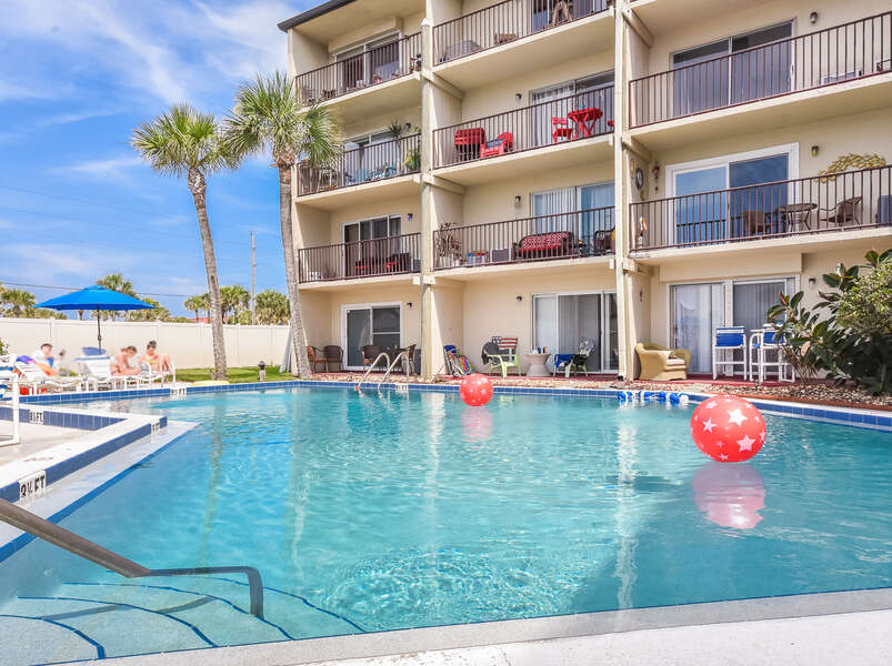 humungous pool located just outside this new smyrna beach apartment rental