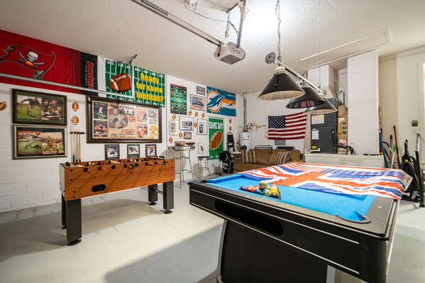 Garage converted to games room featuring pool table and foosball game