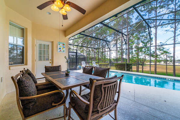 Shaded lanai seating area with patio table and chairs for 6 people