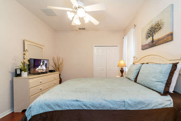 Bedroom 2 has a queen bed, flatscreen TV, double closet and en-suite bathroom