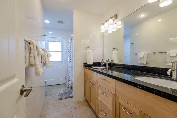 Full Shared Bath with Two Stone Counter Sinks and a Tub/Shower Combo, and Access to the Backyard